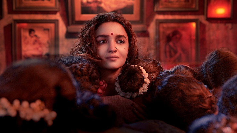 A dimly lit brothel hallway, its walls painted in deep reds and golds, with Gangubai standing at the center, her expression caught between defiance and despair