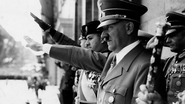 A sea of faces turned upward, arms outstretched, as Hitler delivers a speech from a balcony.