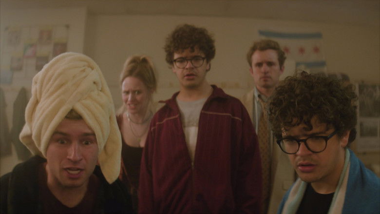 The cramped, fluorescent-lit dorm room where the journey begins, cluttered with textbooks and empty boxes.